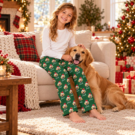 Personalized Christmas Pajama Pants - Santa & Name (Kids), worn by a model relaxing on a sofa with a pet.