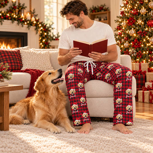 Personalized Christmas Pajama Pants - Santa & Name, worn by a model relaxing on a sofa with a pet.