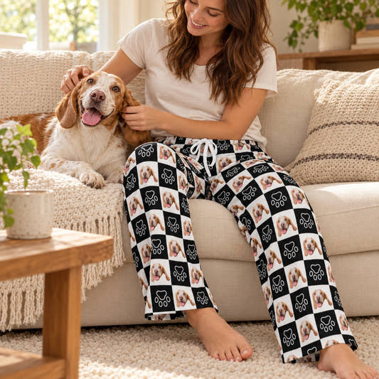 Personalized Pet Pants Black and White Pet Unisex Pajama Pants, shown in the original print on a seated model with a pet in a warm home.